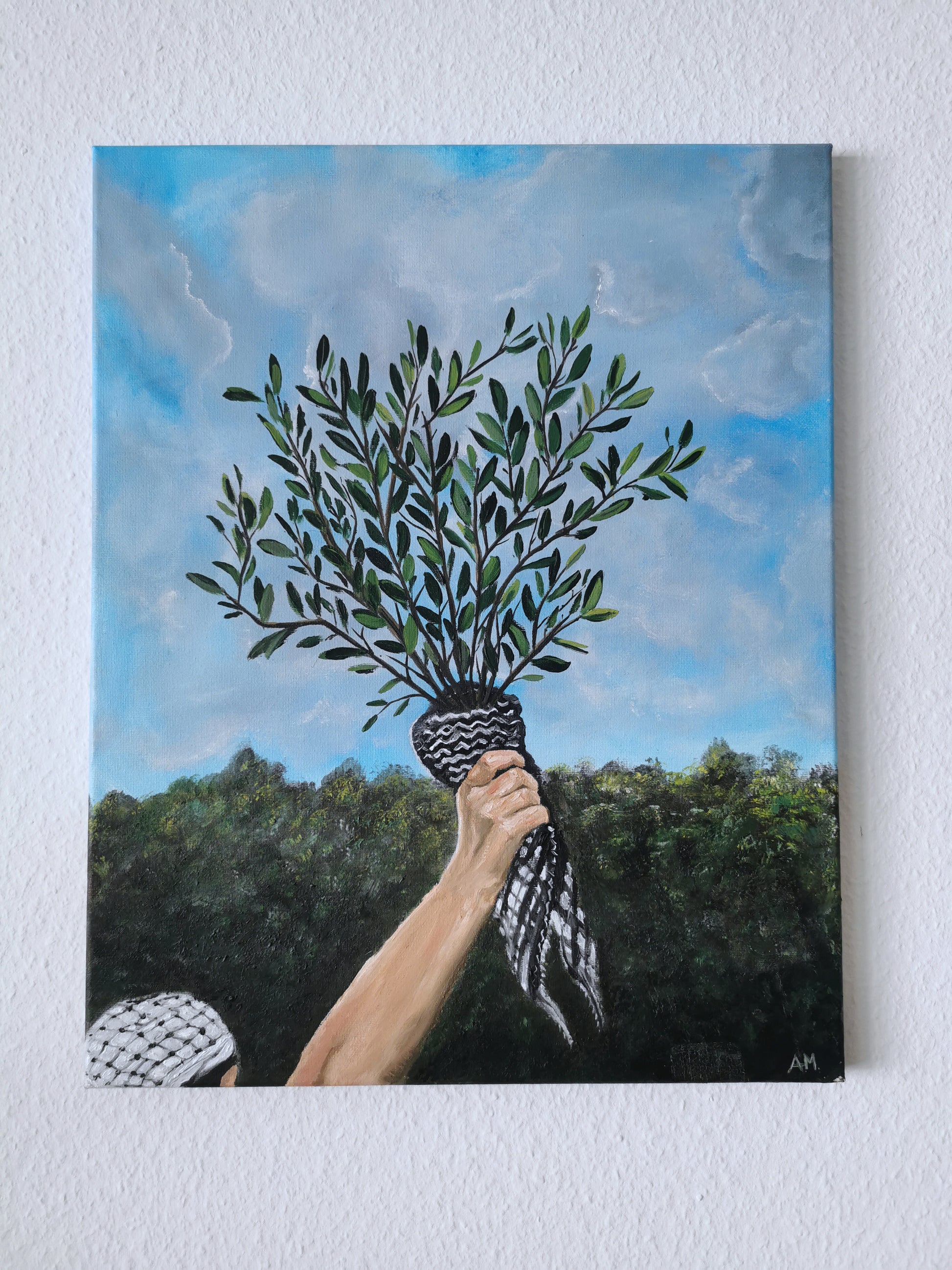 Painting of a hand holding olive branches with a landscape background